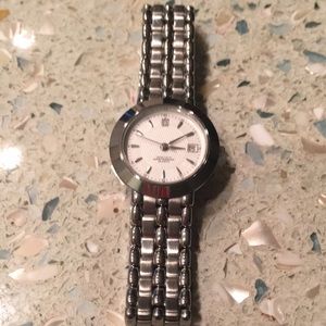 Women’s stainless steel watch. Woven chain band on/off clasp. Water resistant.